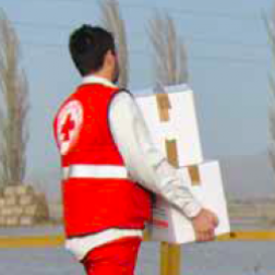Volunteer carrying aid in flooding